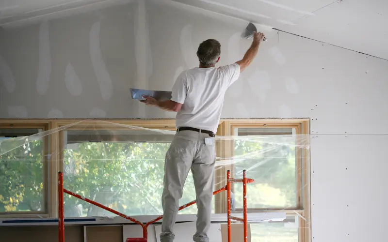 applying mud to wall